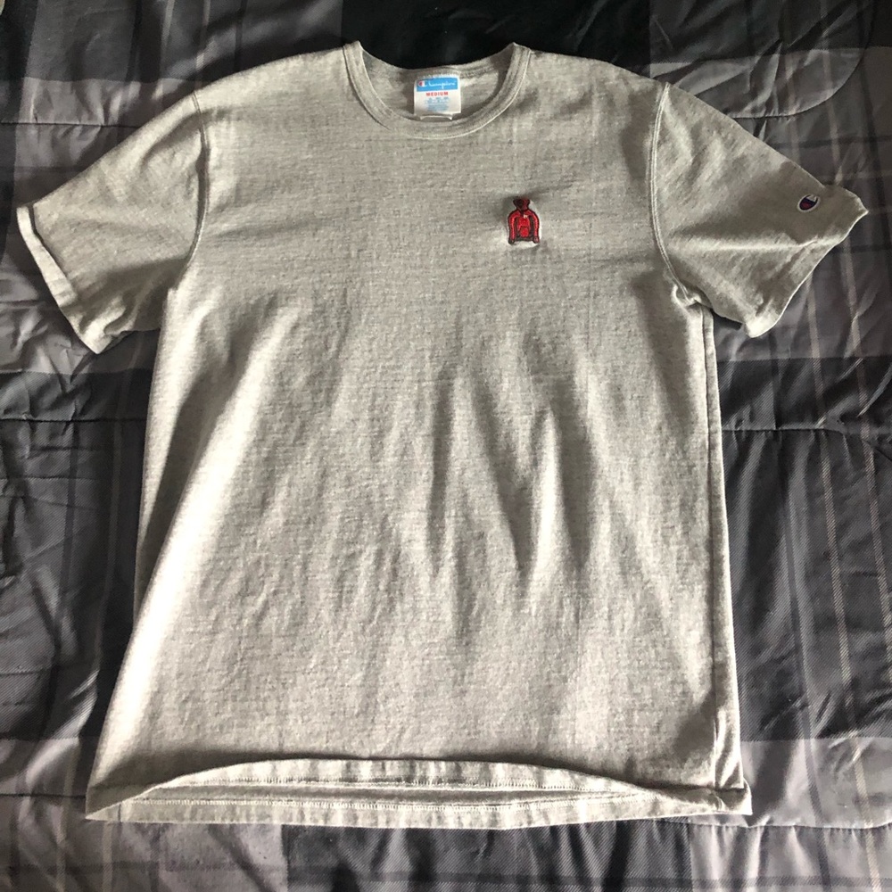 Champion grey t shirt with a red chest decal